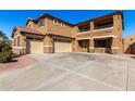 Two-story house with a three-car garage and a large driveway at 17584 W Andora St, Surprise, AZ 85388