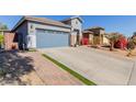 House exterior showcasing a two-car garage and a neatly landscaped yard at 17962 W Vogel Ave, Waddell, AZ 85355