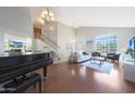 Bright living room featuring hardwood floors, high ceilings, and a grand piano at 18239 N 46Th St, Phoenix, AZ 85032