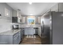 Modern kitchen with stainless steel appliances, granite countertops, and subway tile backsplash at 1865 W 3Rd Pl, Mesa, AZ 85201