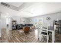 Open-concept living area with a gray sofa, hardwood floors, and natural light at 1865 W 3Rd Pl, Mesa, AZ 85201