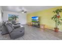 Bright living room with gray sectional sofa and large TV at 2008 W Campbell Ave, Phoenix, AZ 85015