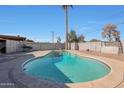 Inviting kidney-shaped pool with a large surrounding patio at 2008 W Campbell Ave, Phoenix, AZ 85015