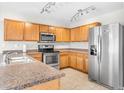 Kitchen with stainless steel appliances and wood cabinets at 2119 W Vineyard Plains Dr, San Tan Valley, AZ 85144