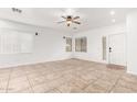 Bright living room with tile floors and ceiling fan at 21362 E Puesta Del Sol Rd, Queen Creek, AZ 85142