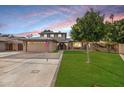 Two-story house with a landscaped lawn and attached garage at 2238 S Estrella Cir, Mesa, AZ 85202