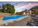 Inviting backyard pool with patio furniture and string lights at 2238 S Estrella Cir, Mesa, AZ 85202