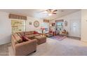 Spacious living room with brown couches and a ceiling fan at 2263 N Trekell Rd # 72, Casa Grande, AZ 85122