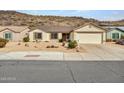 House exterior featuring a desert landscape and attached garage at 22667 N 30Th Ave, Phoenix, AZ 85027