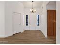 Bright foyer with wood-look floors and chandelier at 23827 N 44Th Ln, Glendale, AZ 85310