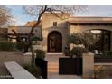 Stunning home featuring a custom front entrance, mature trees, and beautiful stone at 27545 N 97Th Pl, Scottsdale, AZ 85262