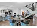 Cozy dining area featuring a modern light fixture, staircase, and seamless flow to other living spaces at 2912 E Clarendon Ave, Phoenix, AZ 85016