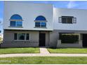 Two-story townhome featuring a well-manicured lawn and charming architectural details at 2912 E Clarendon Ave, Phoenix, AZ 85016