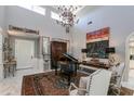 Elegant living room featuring high ceilings, a grand piano, and ornate decor at 3047 E Marshall Ave, Phoenix, AZ 85016