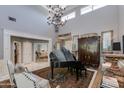 Spacious living room with high ceilings, a grand piano, and an open floor plan at 3047 E Marshall Ave, Phoenix, AZ 85016