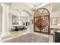 Spacious foyer with a grand arched doorway, light tile flooring, and views into the formal dining room at 402 E Windmere Dr, Phoenix, AZ 85048