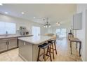 Modern kitchen with island, stainless steel appliances, and white cabinets at 5153 W Pontiac Dr, Glendale, AZ 85308