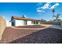 Landscaped backyard with a covered patio and block wall at 5331 W Mescal St, Glendale, AZ 85304