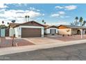 House exterior with a two-car garage and desert landscaping at 5331 W Mescal St, Glendale, AZ 85304