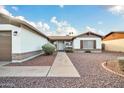 Front entry of a single-story home with walkway and landscaping at 5331 W Mescal St, Glendale, AZ 85304