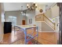 Two story living room with hardwood floors, high ceilings and a large, open staircase at 6282 W Rose Garden Ln, Glendale, AZ 85308