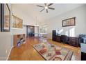 Living room features hardwood floors, a ceiling fan, and built in workspace at 6282 W Rose Garden Ln, Glendale, AZ 85308