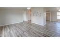 Living room with wood-look floors and neutral walls at 645 S Warren Rd, Maricopa, AZ 85139