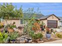 House exterior showcasing abundant landscaping and a large yard at 7215 W Mclellan Rd, Glendale, AZ 85303