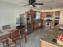 Bright kitchen features stainless steel appliances and wood cabinets at 7940 W Avalon Dr, Phoenix, AZ 85033