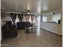 Relaxing living room with tiled floors and comfortable seating at 7940 W Avalon Dr, Phoenix, AZ 85033