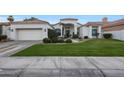 White stucco home with tile roof, 2-car garage, and manicured lawn at 8245 E Jenan Dr, Scottsdale, AZ 85260