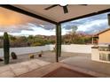 Inviting covered patio with stunning mountain views and built-in grill, perfect for outdoor entertaining at 9546 E Anasazi Pl, Gold Canyon, AZ 85118