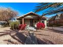 House exterior with red flowers and palm trees at 1002 E Palm Ln, Phoenix, AZ 85006