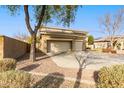Two-story house with three-car garage and mature trees at 1078 W Spur Ct, Gilbert, AZ 85233