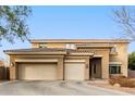 Two-story house with three-car garage and desert landscaping at 1078 W Spur Ct, Gilbert, AZ 85233