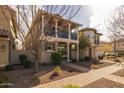 Two-story home with balcony, brick facade, and walkway at 1094 S Agnes Ln, Gilbert, AZ 85296