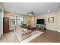 Living room with hardwood floors, two sofas, and a TV at 1094 S Agnes Ln, Gilbert, AZ 85296