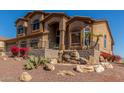 Beautiful multi-level home with a stone waterfall feature in the landscaped front yard at 14829 N 18Th Pl, Phoenix, AZ 85022