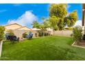 Spacious backyard with artificial turf and fire pit at 15348 W Banff Ln, Surprise, AZ 85379