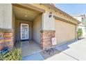 Front entry with decorative door and brick accents at 17198 W Fetlock Trl, Surprise, AZ 85387