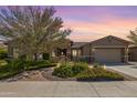 Single-story home with landscaped yard and two-car garage at 18111 W Desert Sage Dr, Goodyear, AZ 85338