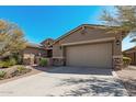 Single story home with stone accents and desert landscaping at 18111 W Desert Sage Dr, Goodyear, AZ 85338