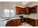 Modern kitchen with dark wood cabinets and quartz countertops at 18429 N 16Th Way, Phoenix, AZ 85022