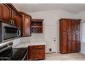 Updated kitchen, featuring dark wood cabinets and pantry at 18429 N 16Th Way, Phoenix, AZ 85022