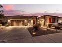 Lovely home with a three-car garage and nicely landscaped front yard at 19000 E Old Beau Trl, Queen Creek, AZ 85142