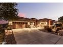 Beautiful home with a two-car garage and well-manicured landscaping at 19000 E Old Beau Trl, Queen Creek, AZ 85142