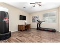 Versatile room with wood-look tile, ceiling fan and ample space, perfect for a home gym at 2036 E Stacey Rd, Gilbert, AZ 85298