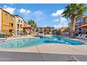 Community pool with lounge chairs and patio umbrellas at 2150 W Alameda Rd # 1313, Phoenix, AZ 85085