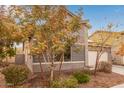 Gray exterior home with two-car garage, landscaping, and partial view of neighboring home at 2181 N 211Th Dr, Buckeye, AZ 85396