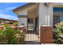 Charming front entrance with a brick gated courtyard and well-maintained landscaping at 2201 N Comanche Dr # 1075, Chandler, AZ 85224